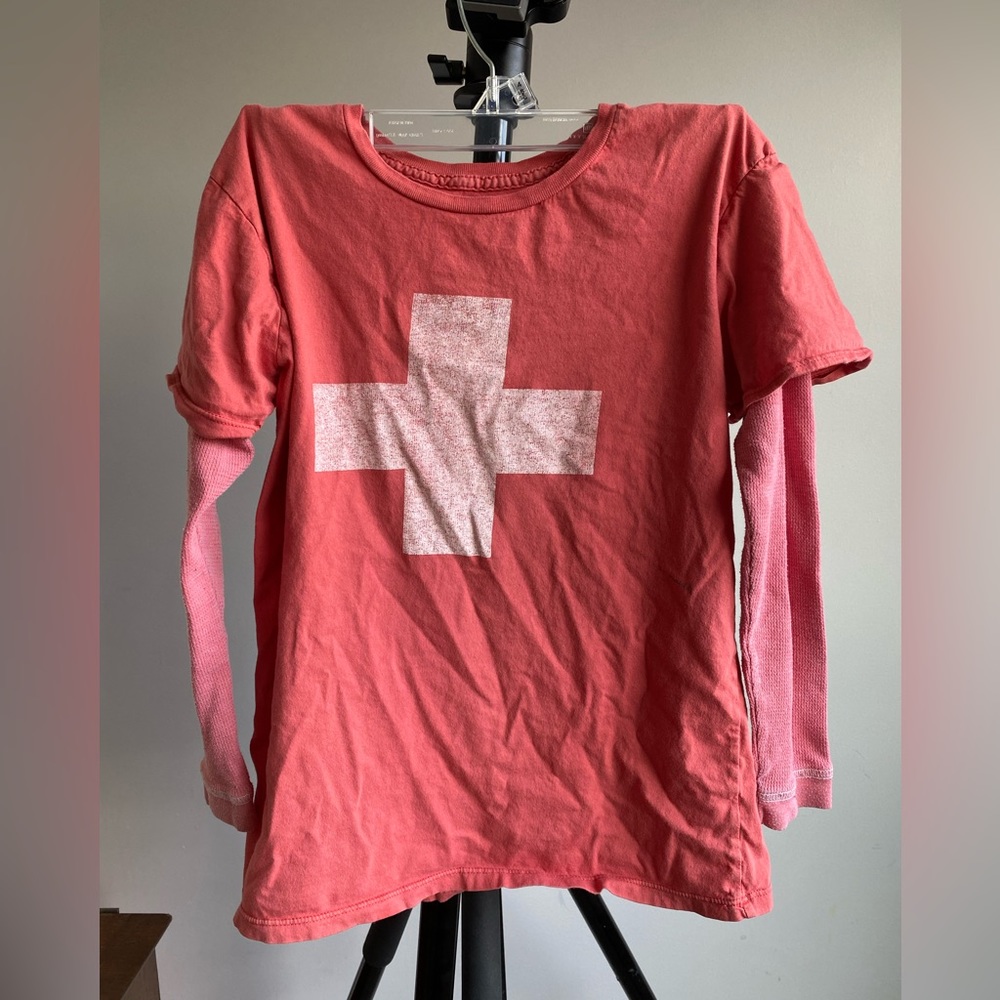 Long sleeved red shirt with a lifeguard symbol